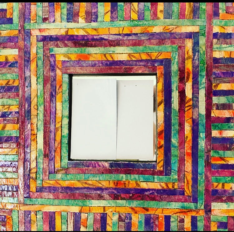 The freewheeling colors of this wooden mirror started by my hand coloring heavy paper using mixed media, at which time they were shredded, then applied mosaic style to create this keepsake to cherish.